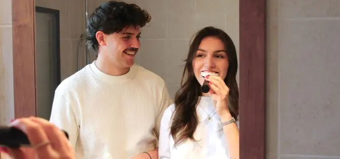A person uses the sonic mouthpiece toothbrush